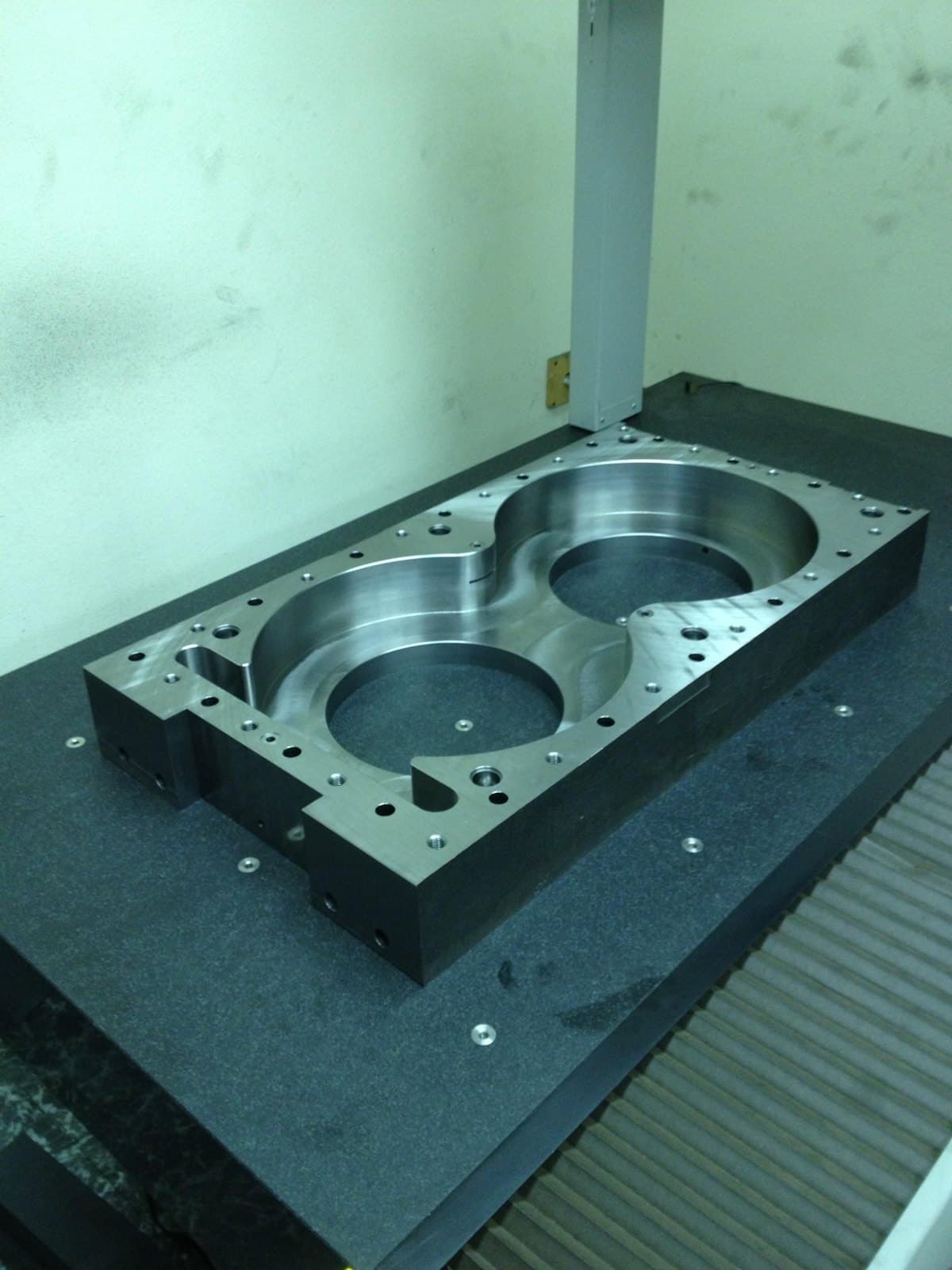 Machined gear housing casting with several circular bores.